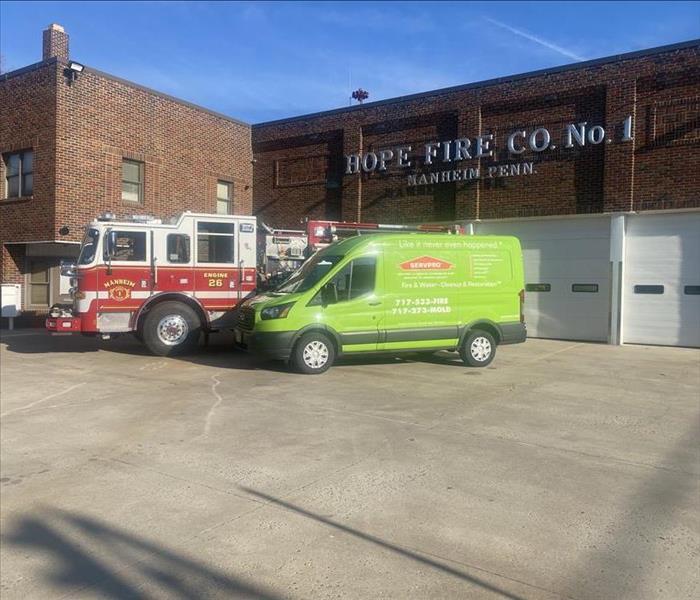 SERVPRO van and fire truck in front of fire station