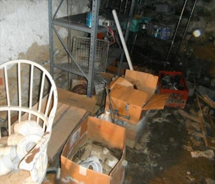 flooded moldy basement with cluttered shelf and boxes
