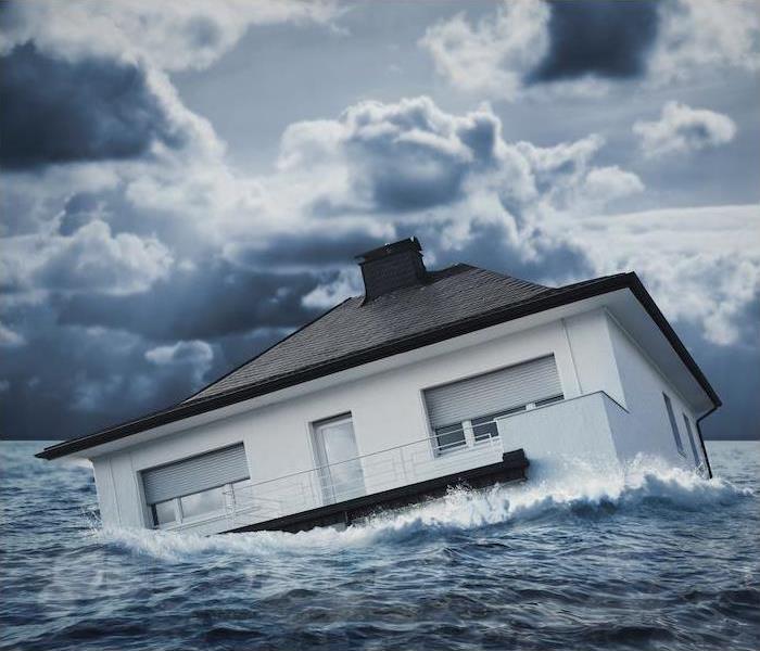 < img src =”house.jpg” alt = “a house floating in a large body of water" >