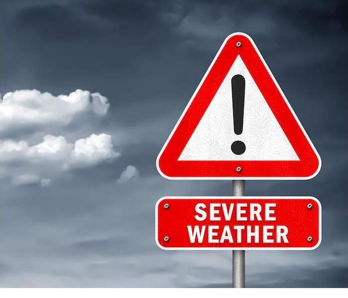 severe weather red sign with dark cloudy sky in background 