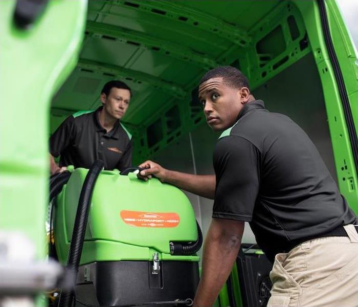 < img src =”equipment.jpg” alt = "two SERVPRO employees unloading cleaning equipment out of a green van"   >